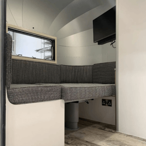 Multifunctional seating and bedding area in Airstream style caravan - hand built in the UK