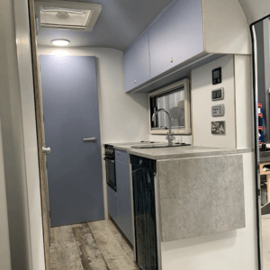 Custom interior kitchen diner area of airstream style touring caravan